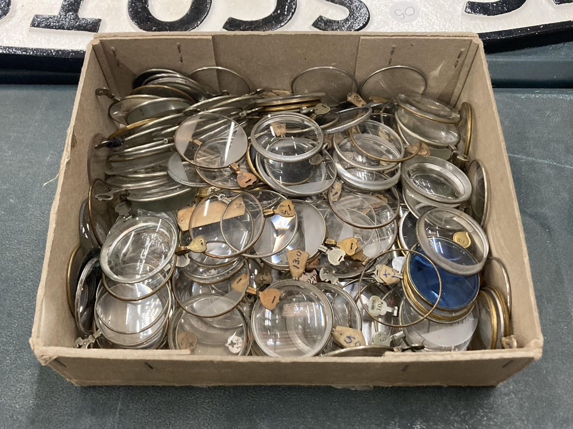A BOX OF VINTAGE OPTICIAN'S OPTICAL GLASS LENSES