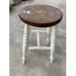 A VINTAGE PINE AND PARTIALLY PAINTED FOUR LEGGED STOOL