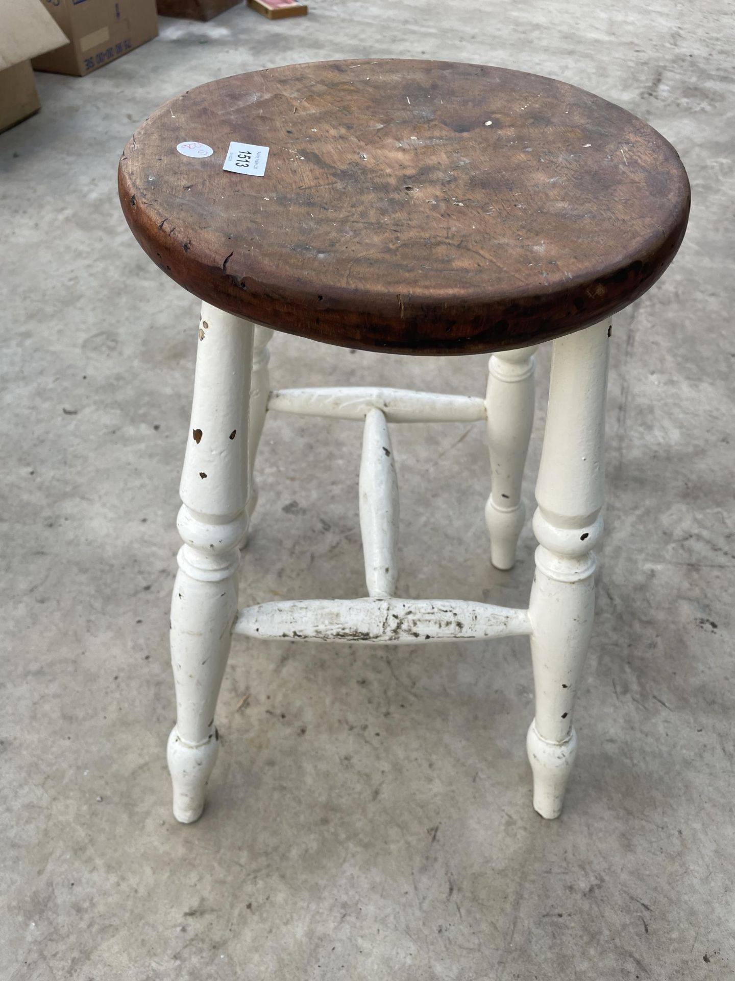 A VINTAGE PINE AND PARTIALLY PAINTED FOUR LEGGED STOOL