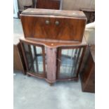 A MID 20TH CENTURY WALNUT COCKTAIL CABINET WITH MIRRORED INTERIOR AND BOWFRONT, ON BALL AND CLAW