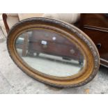 AN OVAL EDWARDIAN WALL MIRROR