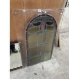 A COLOURED GLAZED AND LEADED WINDOW ENCASED IN PLASTIC FRAME
