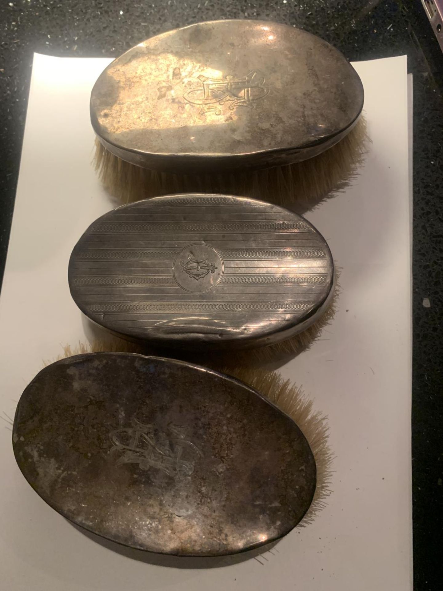 THREE HALLMARKED SILVER BACKED BRUSHES TO INCLUDE TWO BIRMINGHAM AND A CHESTER