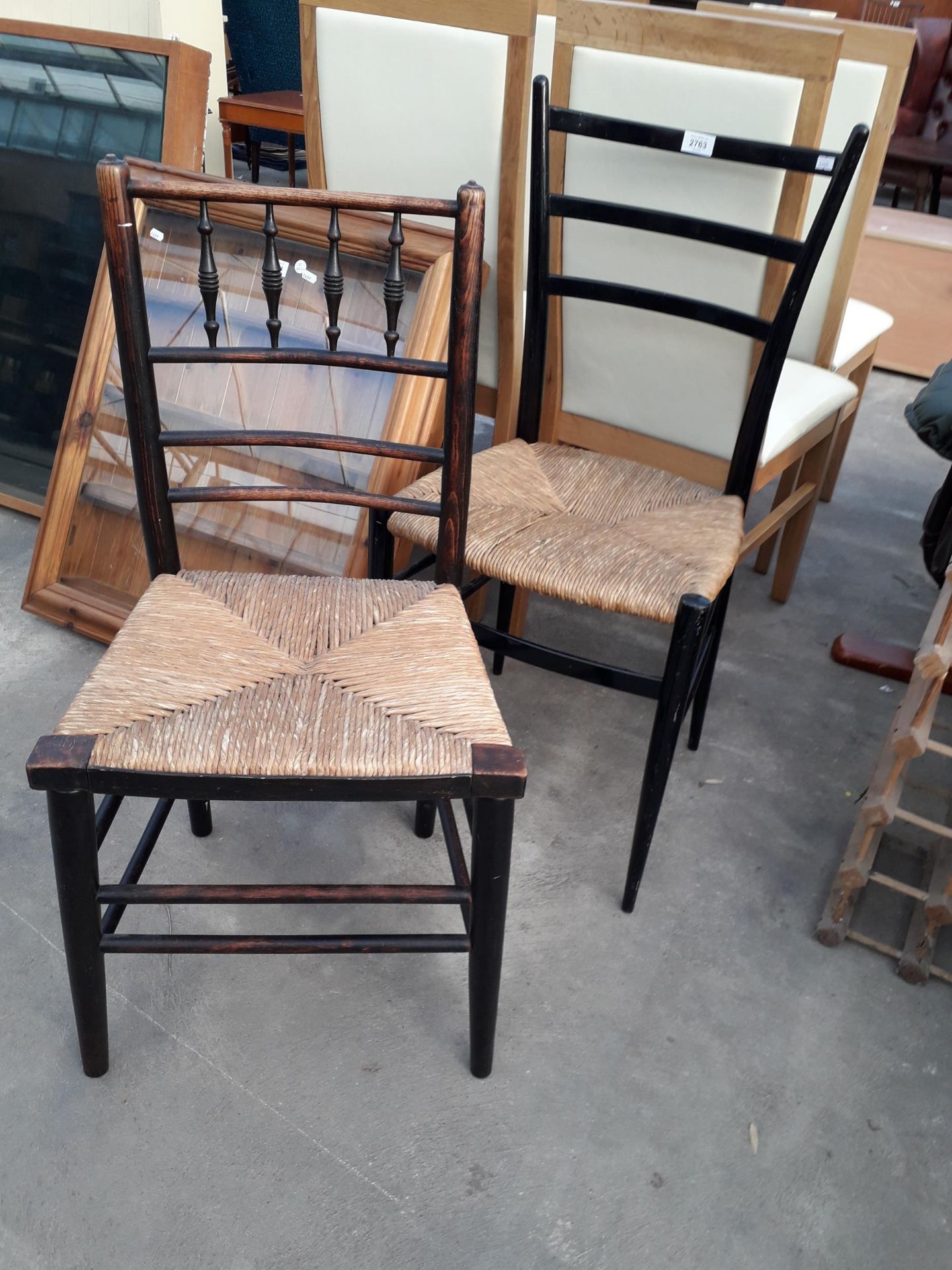 TWO ELM AND BLACK PAINTED SUSSEX TYPE CHAIRS WITH RUSH SEATS