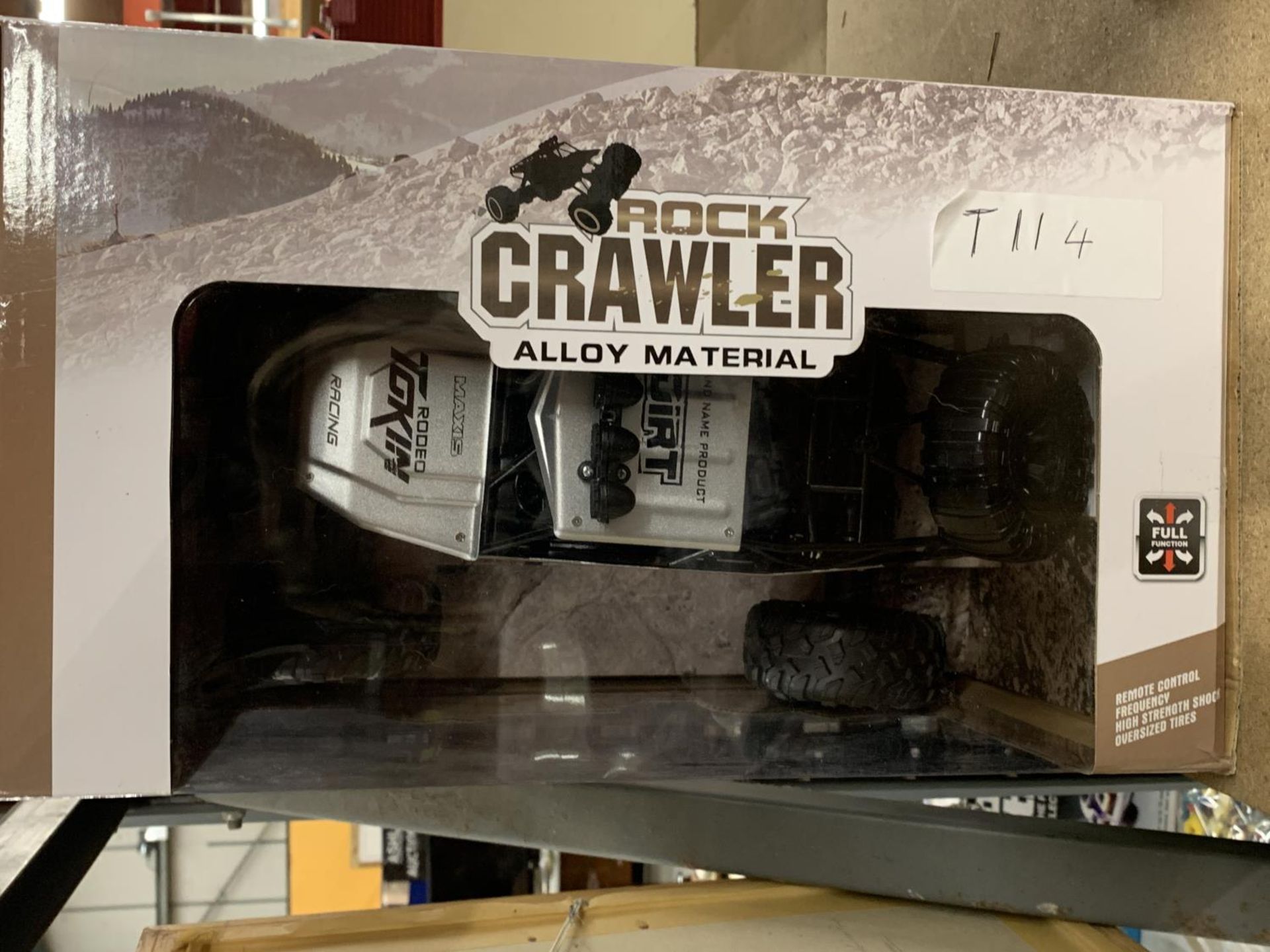 A ROCK CRAWLER REMOTE CONTROL CAR (NEW IN BOX) INCLUDES BATTERIES, CHARGER AND SIX MINI CONES