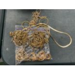 A BAG OF YELLOW METAL COSTUME JEWELLERY CHAINS ETC