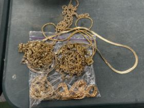 A BAG OF YELLOW METAL COSTUME JEWELLERY CHAINS ETC