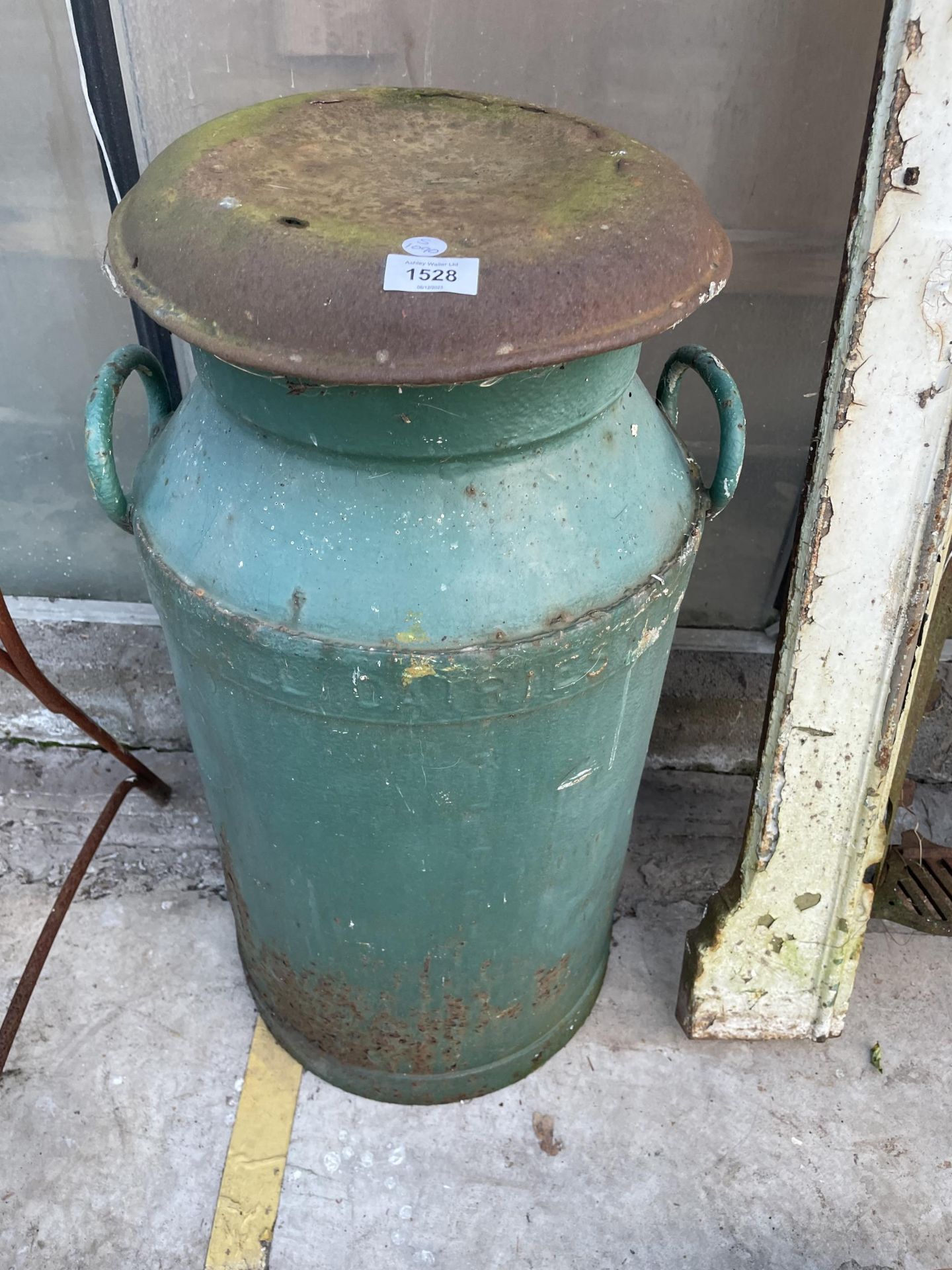 A STEEL MILK CHURN WITH LID