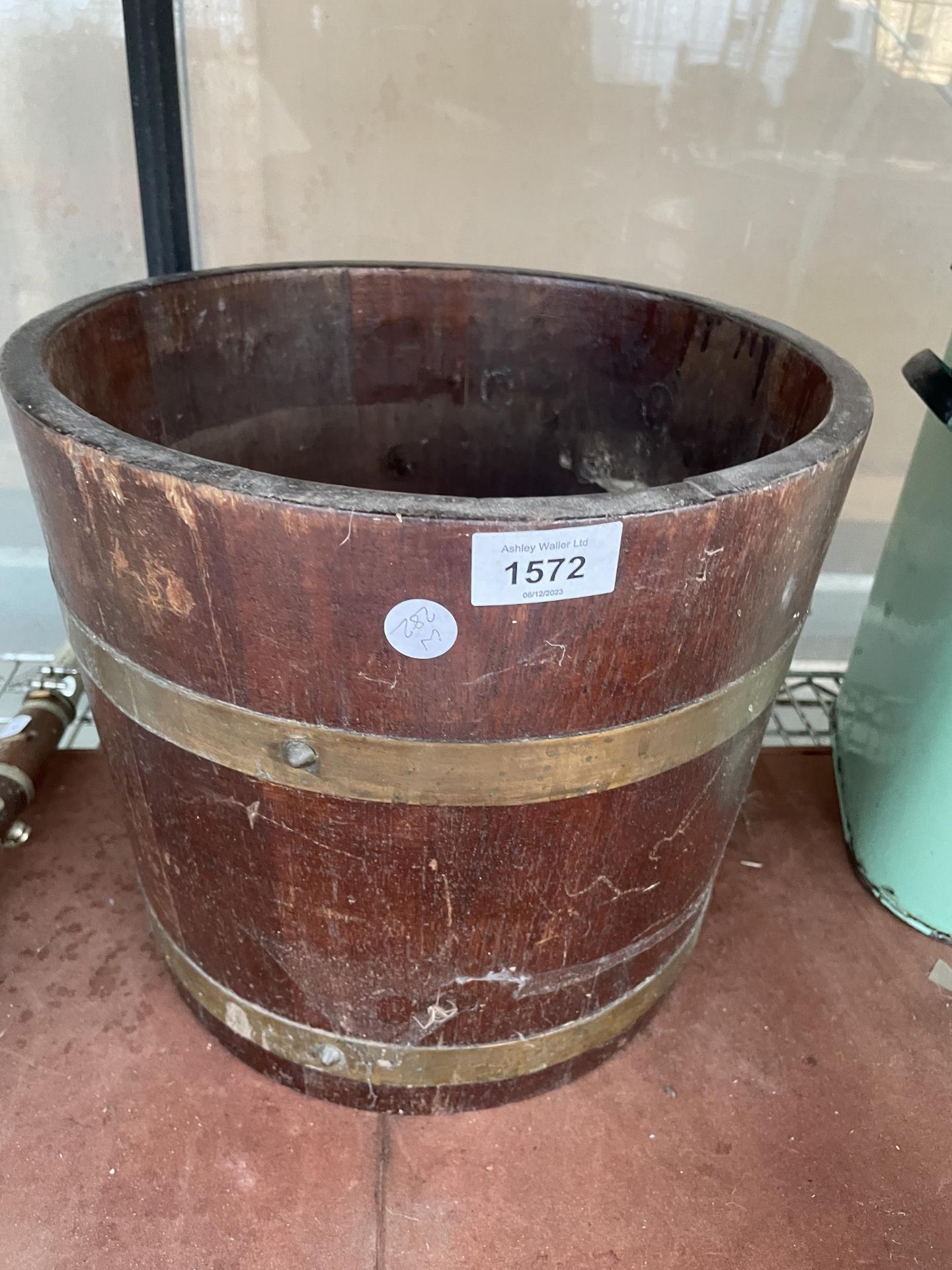 A VINTAGE OAK AND BRASS BANDED HALF BARREL COAL BUCKET