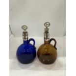 TWO ANTIQUE COLOURED GLASS DECANTERS/FLAGONS WITH SILVER PLATED COLLARS, PORT AND RUM CORKS