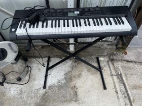 A CASIO ELECTRIC KEYBOARD WITH STAND