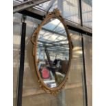 A DECORATIVE WALL MIRROR WITH MOULDED FRAME