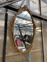 A DECORATIVE WALL MIRROR WITH MOULDED FRAME