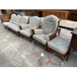 AN ERCOL ELM FOUR PIECE LOUNGE SUITE COMPRISING THREE SEATER SETTEE, TWO EASY CHAIRS AND A STOOL
