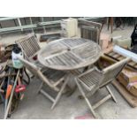 A TEAK GARDEN FURNITURE SET COMPRISING OF A ROUND TABLE AND FOUR CHAIRS