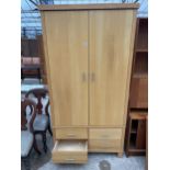 A MODERN TWO DOOR WARDROBE WITH FOUR DRAWERS TO THE BASE, 40" WIDE