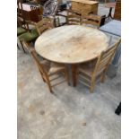 A MODERN 48" DIAMETER PINE DINING TABLE ON TURNED LEGS AND FIVE LADDERBACK DINING CHAIRS