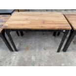AN INDUSTRIAL STYLE TABLE ON CST METAL AND STUDDED LEGS AND FRAME, WITH WOODBLOCK TOP, 47 X 28"
