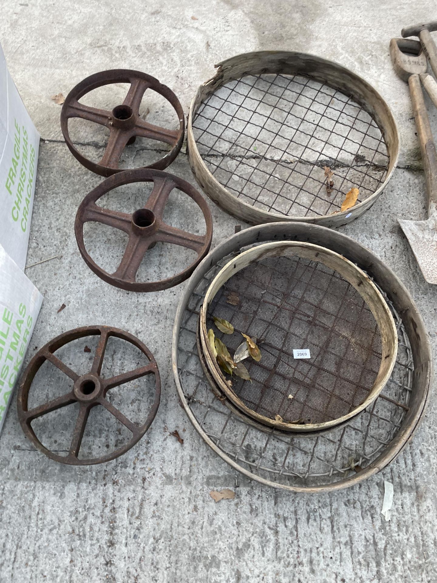 THREE VINTAGE RIDDLE SIEVES AND THREE PULLEY WHEELS