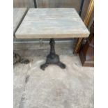 A SQUARE PUB TABLE WITH CAST IRON BASE