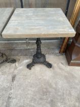 A SQUARE PUB TABLE WITH CAST IRON BASE