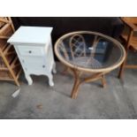 A 26" DIAMETER BAMBOO TABLE WITH GLASS TOP AND WHITE PAINTED BEDSIDE LOCKER