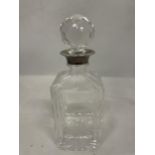 A CUT GLASS DECANTER (STOPPER A/F) WITH A TESTED TO SILVER COLLAR
