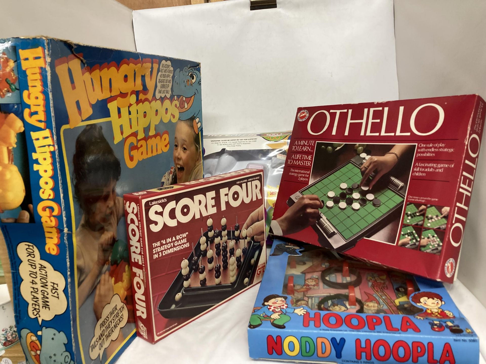 A QUANTITY OF GAMES TO INCLUDE HUNGRY HIPPOS, OTHELLO, SCORE FOUR, NODDY HOOP-LA, ETC