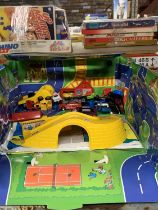 A FOLD UP CAR PLAYMAT WITH A QUANTITY OF CARS