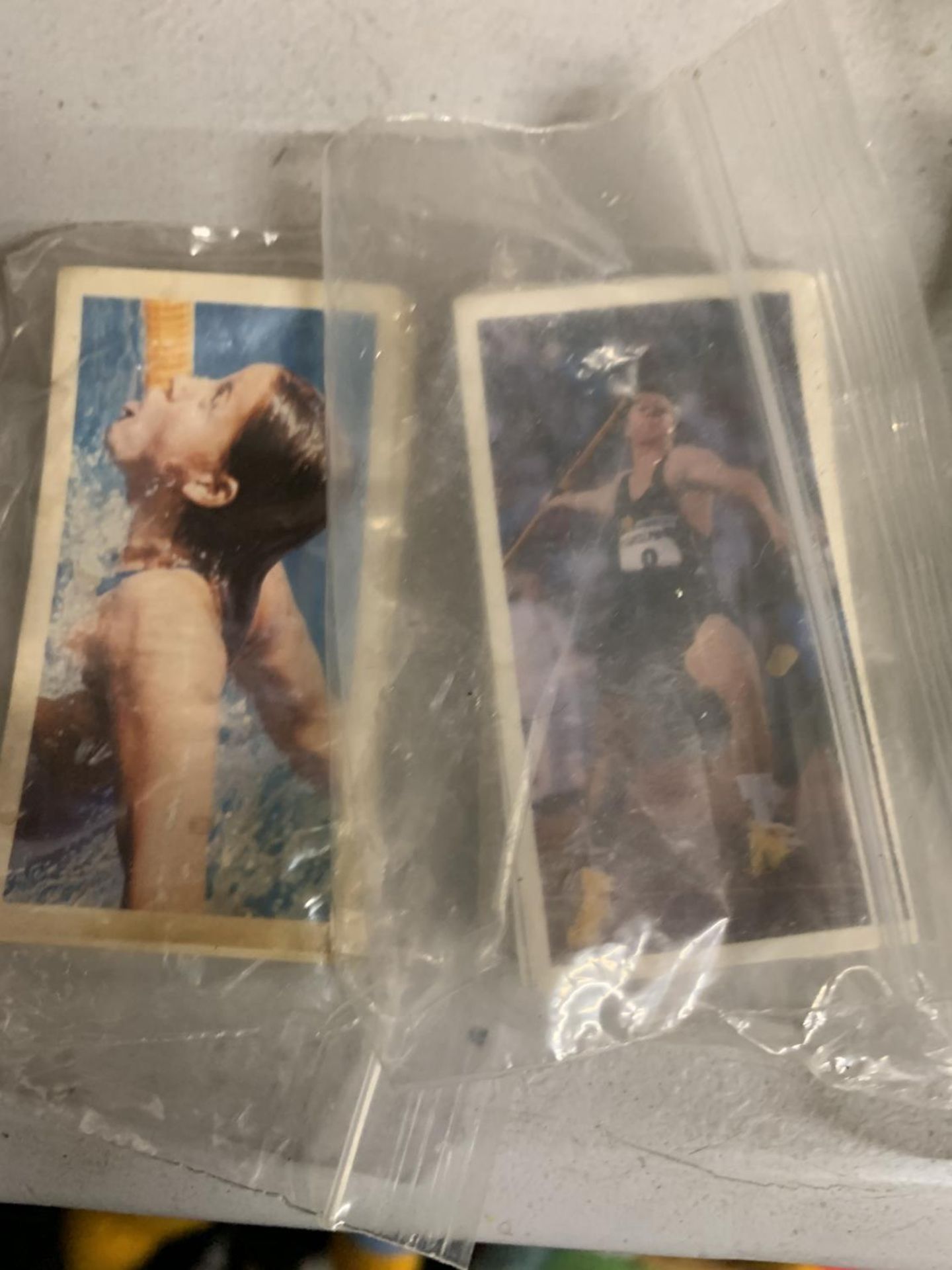 TWO SMALL PACKETS OF OLYMPIC SPORTS CARDS
