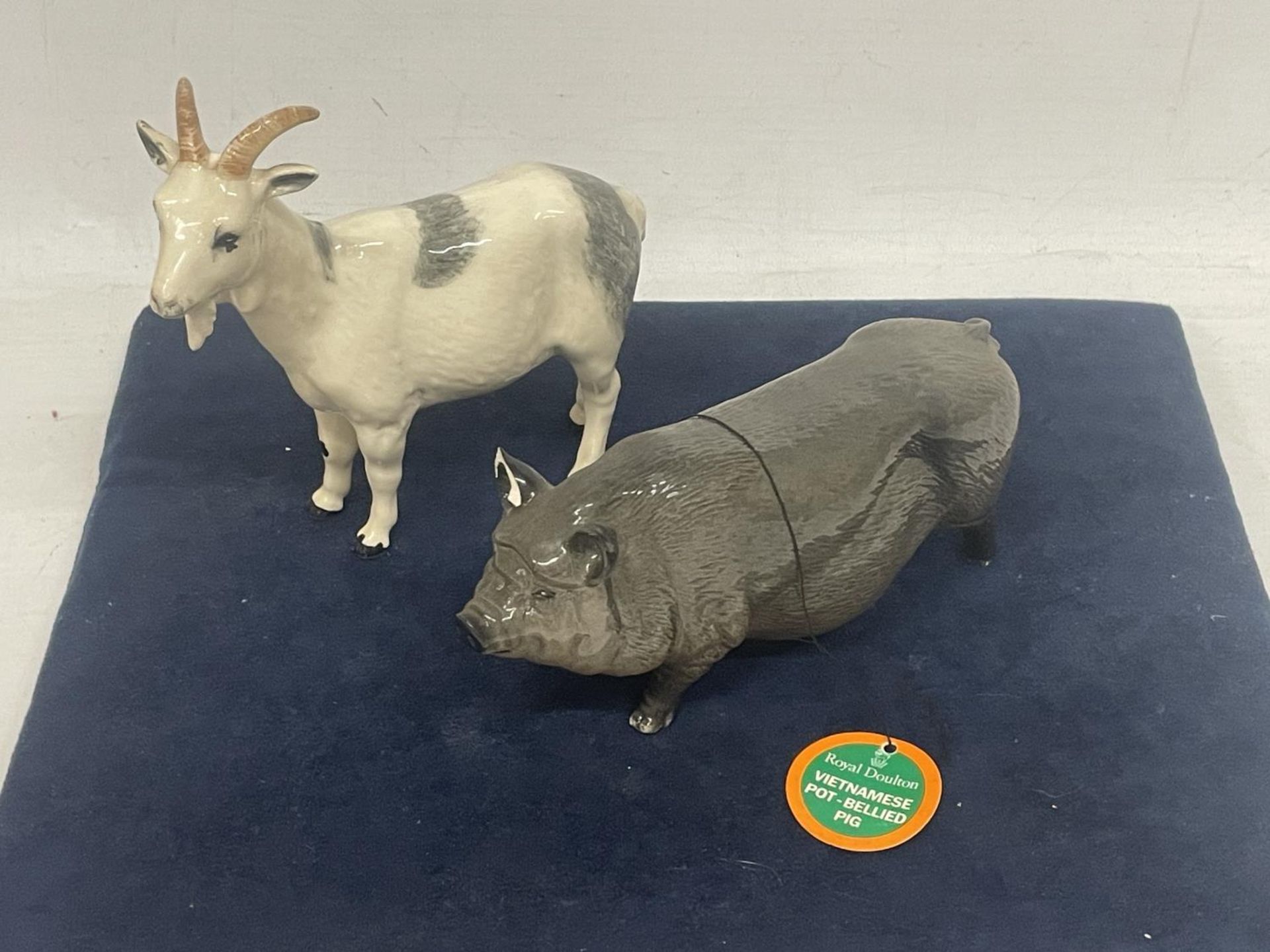TWO FIGURES TO INCLUDE A BESWICK A BILLY GOAT AND A ROYAL DOULTON POT BELLIED PIG (EAR A/F)