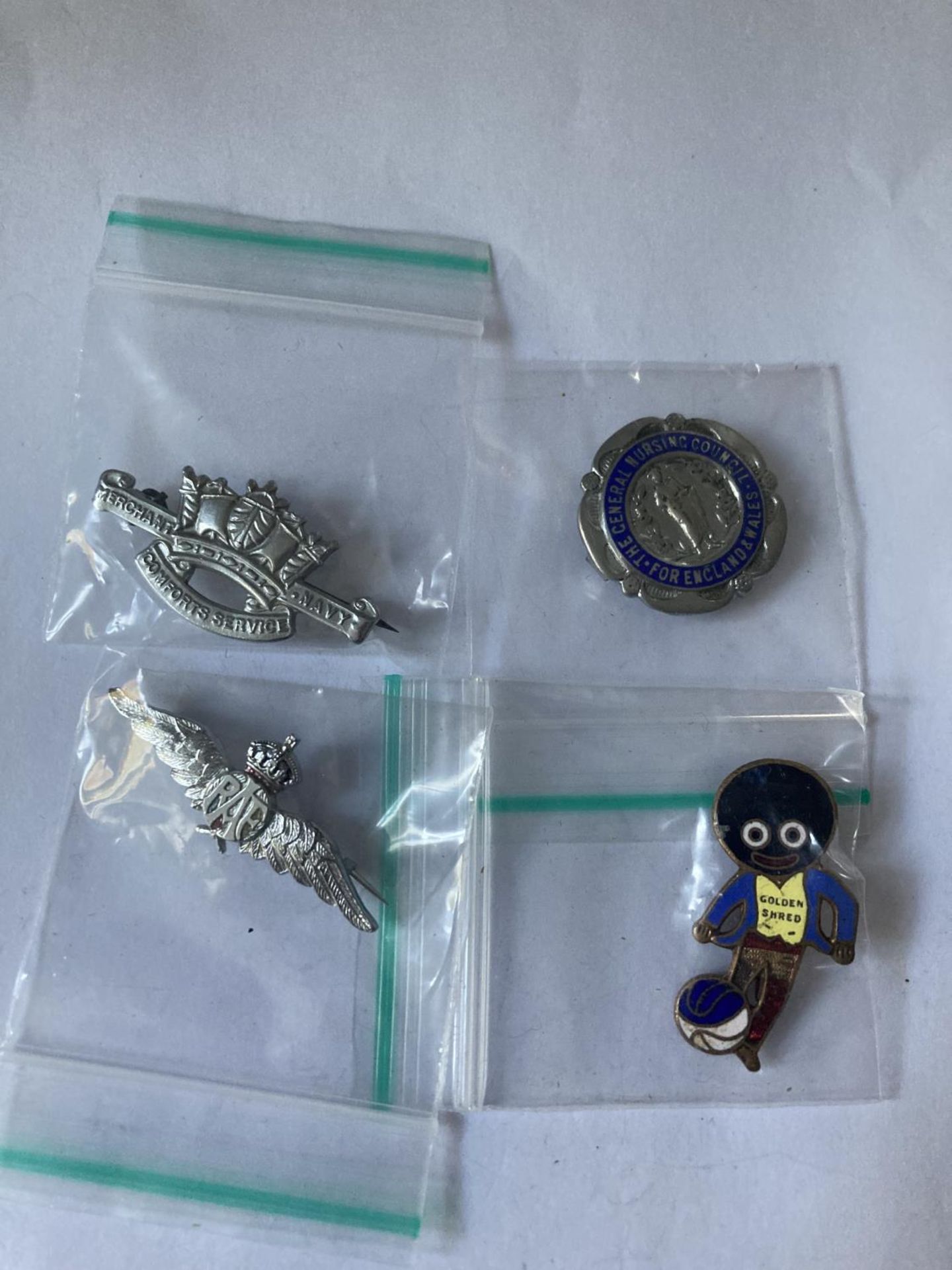 FOUR ASSORTED BADGES INCLUDING NURSING, AIR FORCE AND NAVY ETC