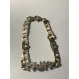 A HEAVY SILVER GILT, STAMPED 925 CURB LINK BRACELET WITH MUM AND TWO HEARTS IN CLEAR STONES