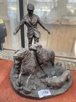 A BRONZED COLD CAST FIGURE OF A FARMER WITH SHEEP AND A SHEEP DOG