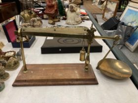 A SET OF VINTAGE BRASS SCALES ON WOODEN BASE