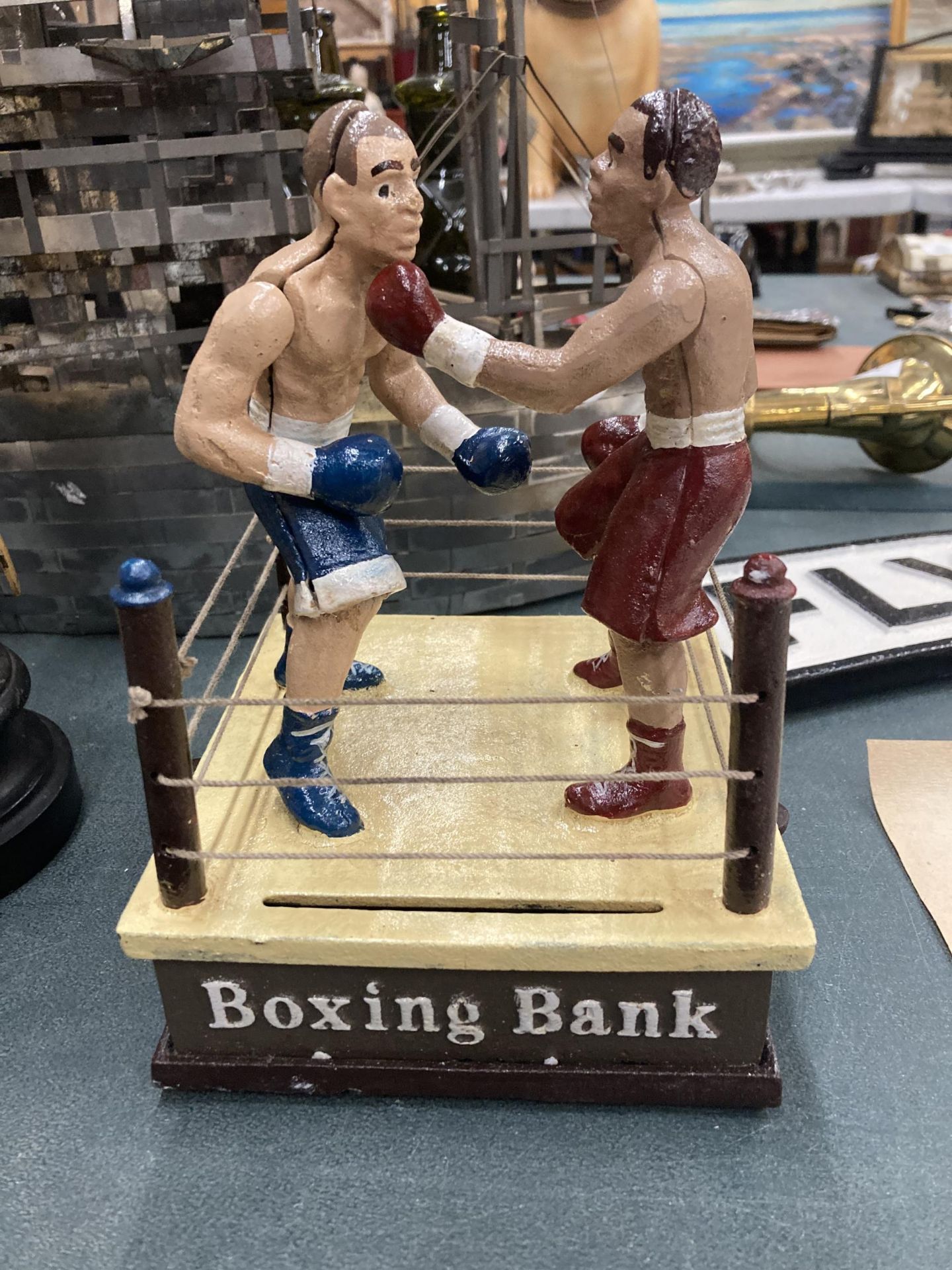 A HEAVY CAST BOXING MONEY BANK, FIGHTERS MOVE AND THROW PUNCHES