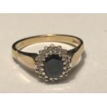 A 9 CARAT GOLD RING WITH CENTRE SAPPHIRE SURROUNDED BY DIAMONDS SIZE M