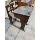 AN EARLY 20TH CENTURY ELM AND OAK CHILDS SCHOOL DESK AND CHAIR WITH ADJUSTABLE WRITING SLOPE