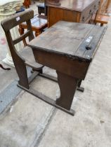 AN EARLY 20TH CENTURY ELM AND OAK CHILDS SCHOOL DESK AND CHAIR WITH ADJUSTABLE WRITING SLOPE