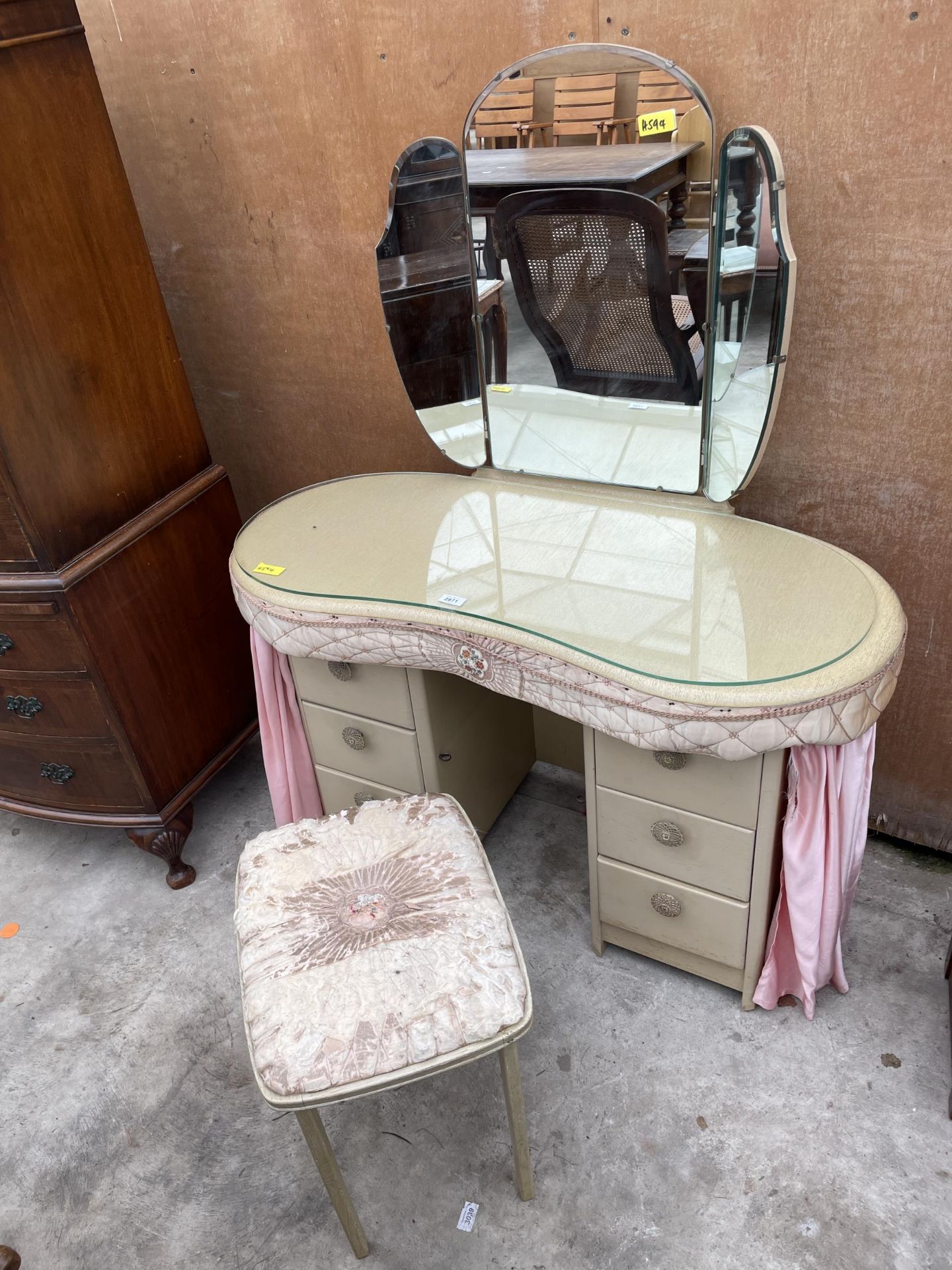 A MID 20TH CENTURY KIDNEY SHAPED DRESSING TABLE WITH PULL ROUND CURTAIN AND MATCHING STOOL