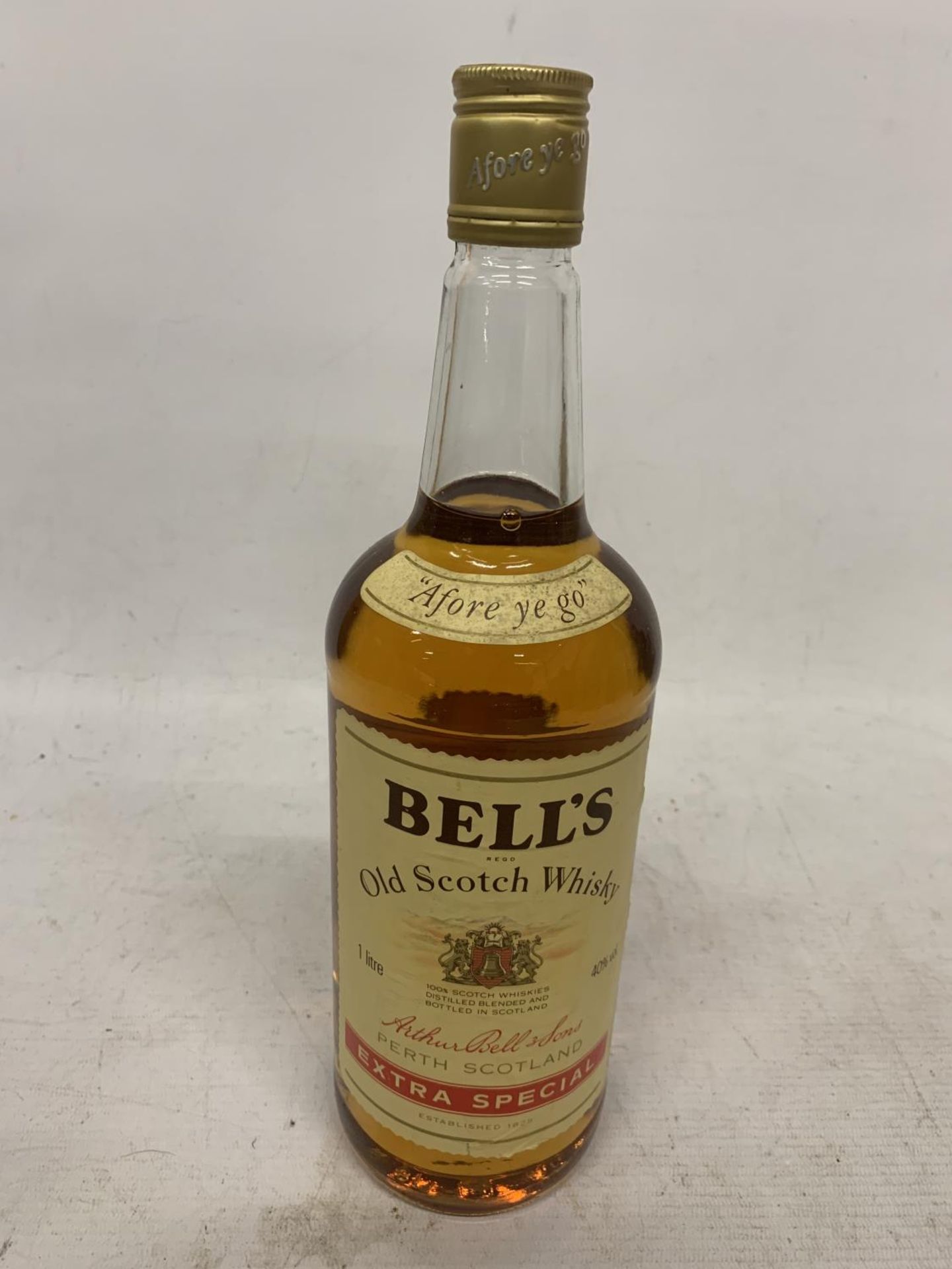 A 1 LITRE BOTTLE OF BELL'S SCOTCH WHISKY