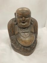 A LARGE CARVED WOODEN BUDDHA FIGURE 13" TALL