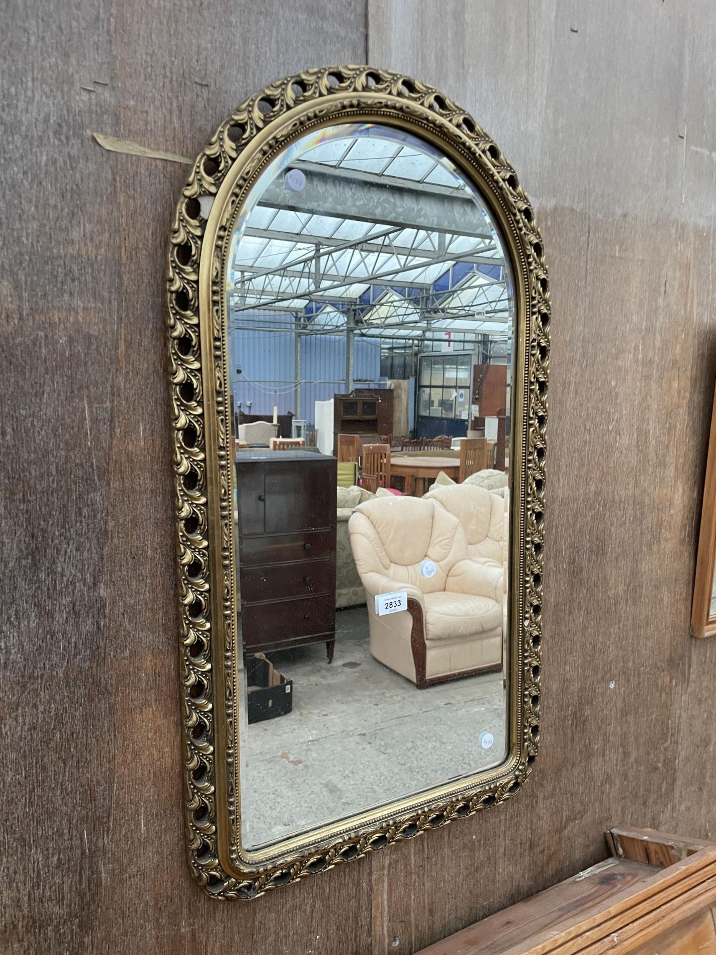 A MODERN GILT FRAMED WALL MIRROR, 34 X 19"