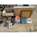 A LARGE ASSORTMENT OF ITEMS TO INCLUDE CRAFT PAPER, A CHESS BOARD AND BOOKS ETC