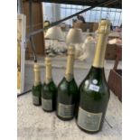 FOUR VARIOUS SIZED GLASS CHAMPAGNE DISPLAY BOTTLES
