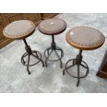 THREE INDUSTRIAL STOOLS ON TUBULAR METAL BASE