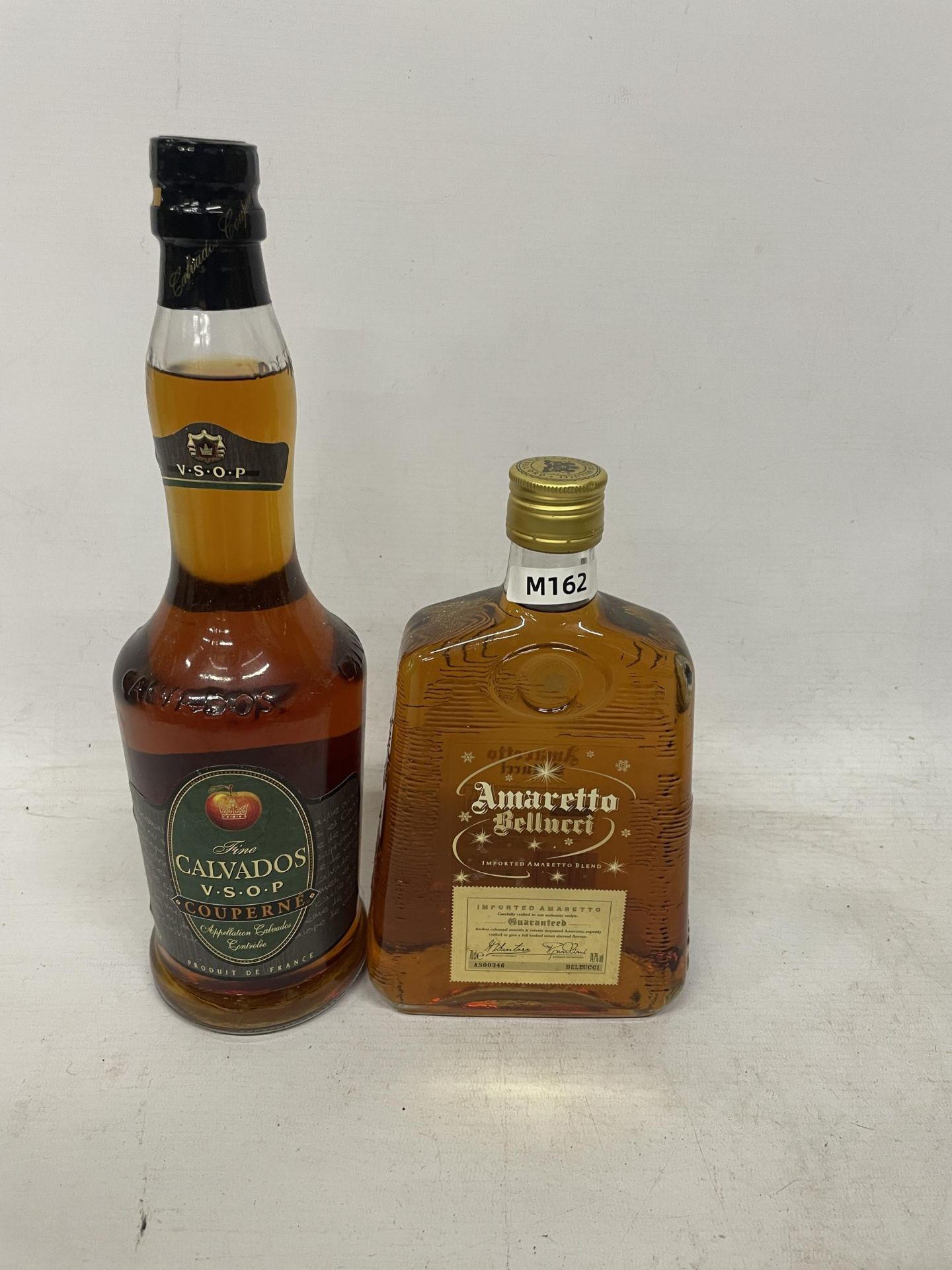 TWO BOTTLES - 70CL AMARETTI BELLUCCI AND 70CL CALVADOS V.S.O.P COUPERNE