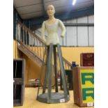 AN UNUSUAL PAINTED WOODEN DOLL ON STAND WITH MOVEABLE ARMS