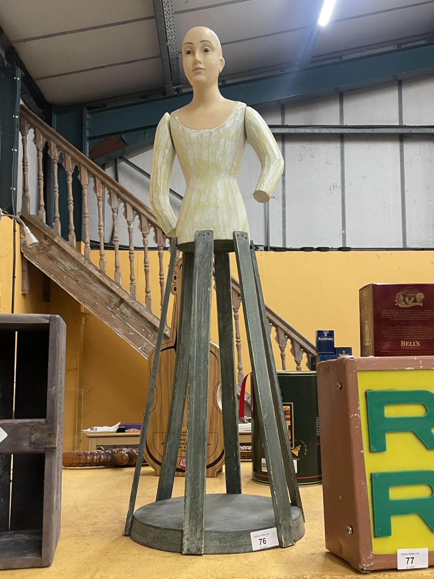 AN UNUSUAL PAINTED WOODEN DOLL ON STAND WITH MOVEABLE ARMS