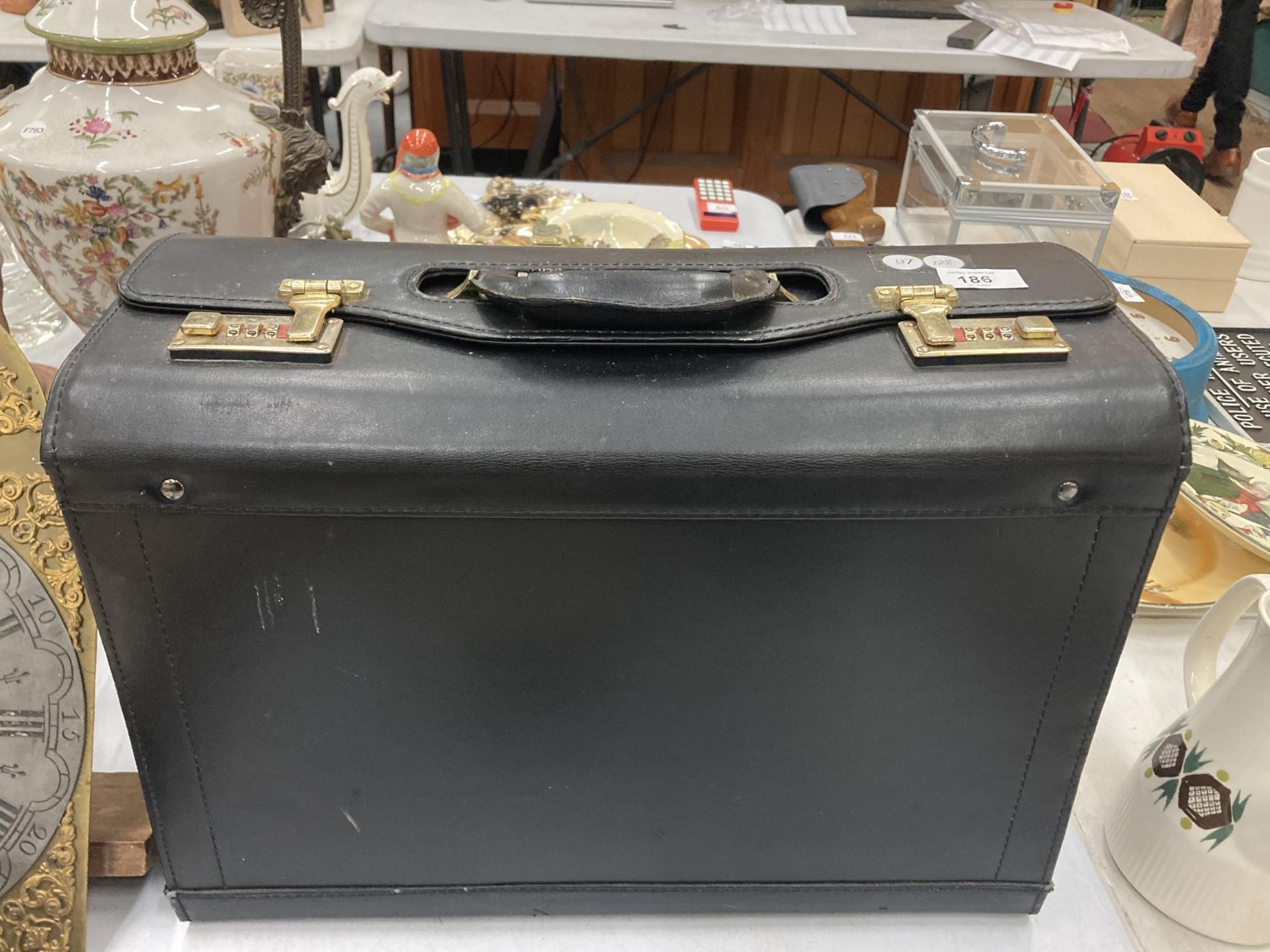 A VINTAGE BLACK SUITCASE WITH CODE LOCKS